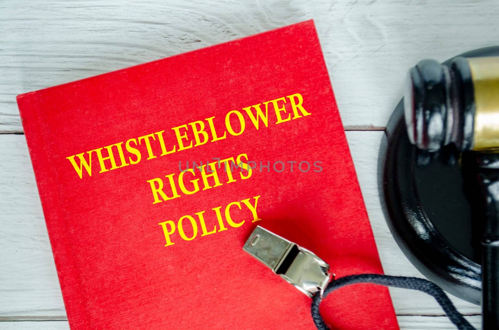 Top view of Whistleblower Right Policies book with whistle and gavel background.