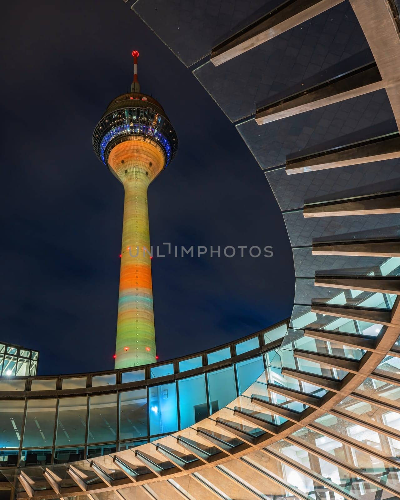DUSSELDORF, GERMANY - MARCH 25, 2023: Illuminated Rhine Tower and state parliament of North Rhine Westphalia on March 25, 2023 in Dusseldorf, Germany, Europe