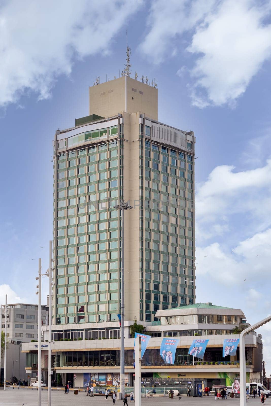 Istanbul, Turkey - May 13, 2023: Exterior of modern architectural design tall building of five stars Marmara hotel, located at Taksim Square, or Taksim Meydani in a spring day