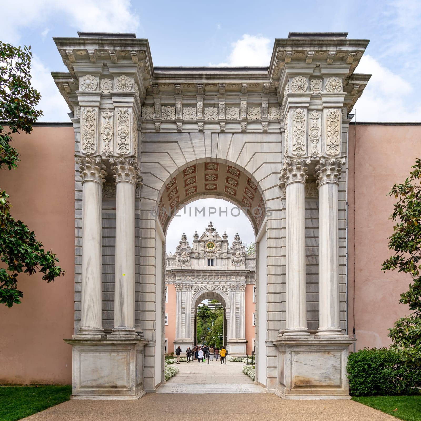 Istanbul, Turkey - May 10, 2023: Entrance of Dolmabahce Palace, with tourists visiting the place - View from the inner courtyard
