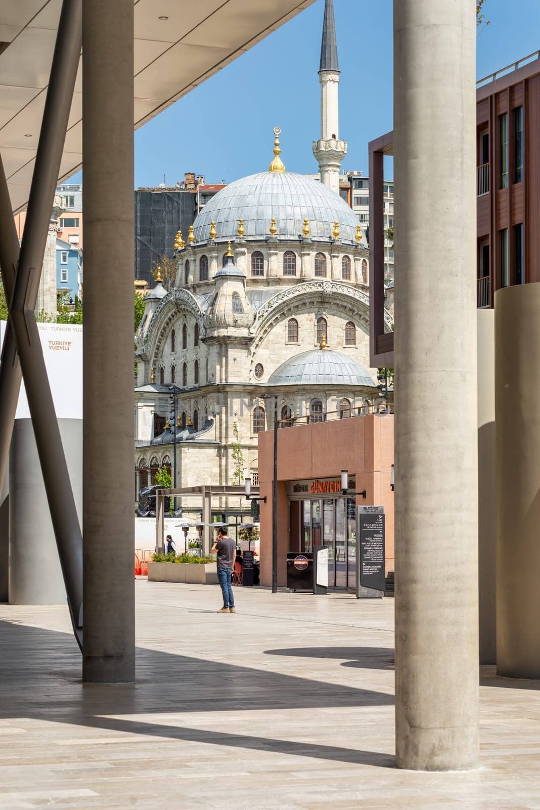 Istanbul, Turkey - May 13, 2023: Nusretiye imperial Ottoman Mosque framed by passage at Istanbul Museum of Modern Art, suited inside Galataport complex, in Karakoy neighborhood, Beyoglu district
