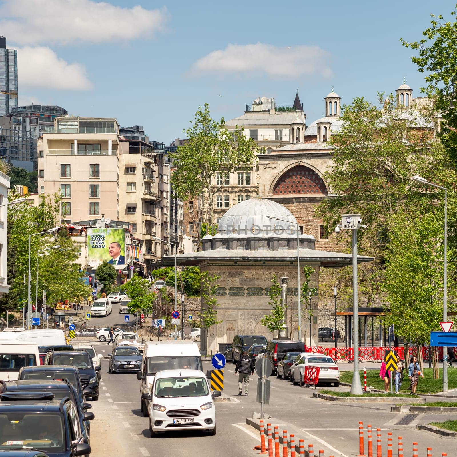 Istanbul, Turkey - May 13, 2023: Crowded Kilic Ali Pasha street, with Kilic Ali Pasha Fountain in the far end, Tophane district of Beyoglu, near to Galataport cruise terminal