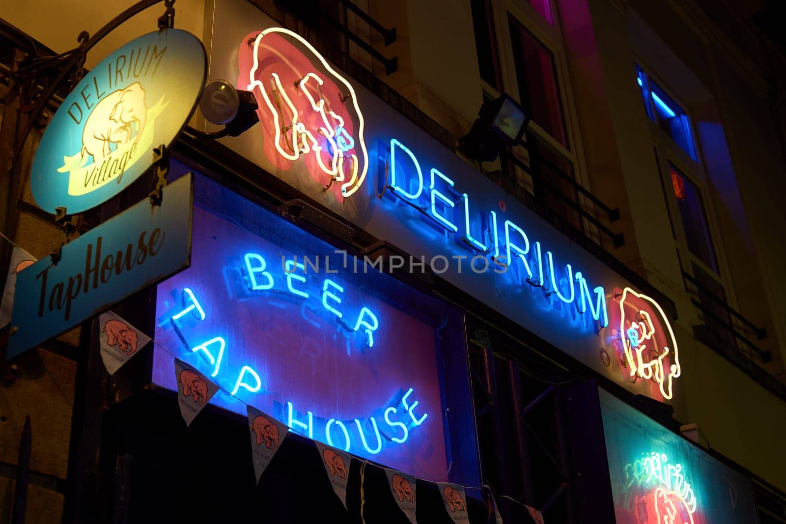 Brussels, Belgium: March 14 2024 - Delirium Village Tap House bar entrance. The place name comes from the beer Delirium Tremens produced by the Huyghe family brewery.