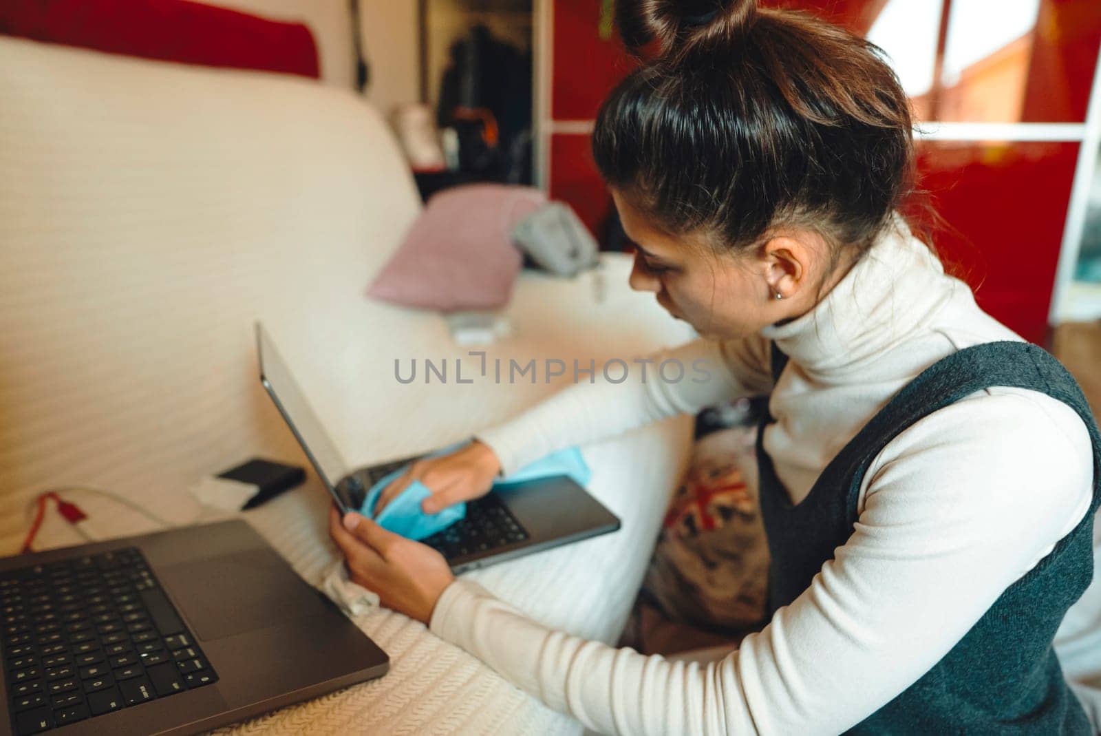 A person multitasks efficiently with laptops, demonstrating remote work and available technology tools