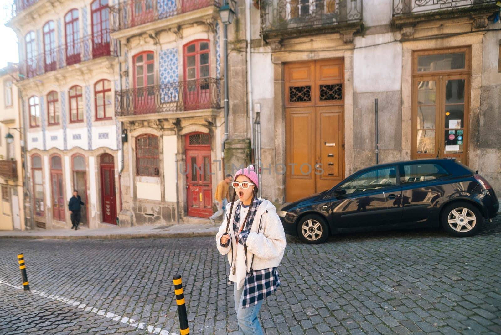 A vibrant street scene showcases a young woman enjoying her time amidst beautiful historic architecture
