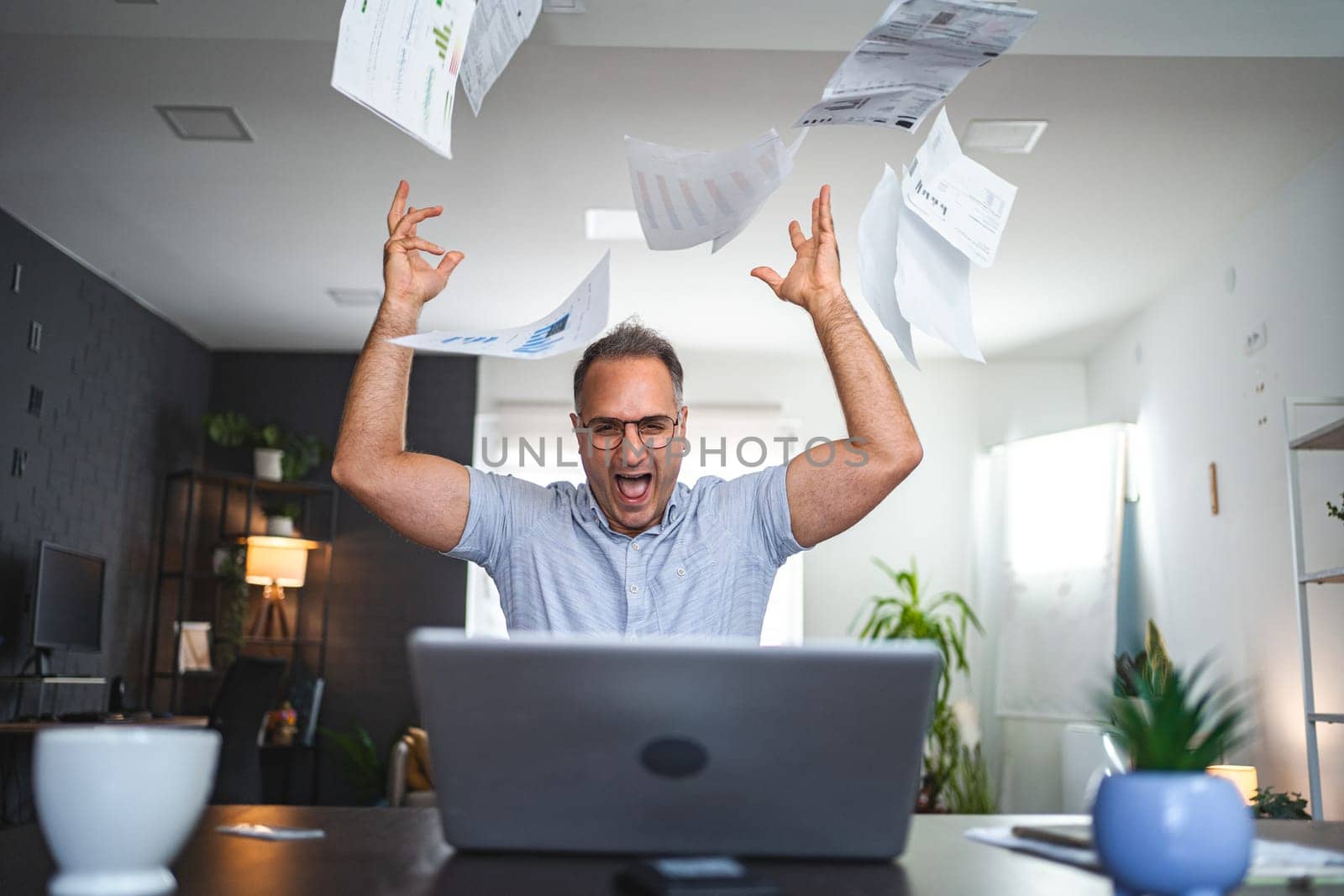Frustrated middle aged Caucasian man working at home.