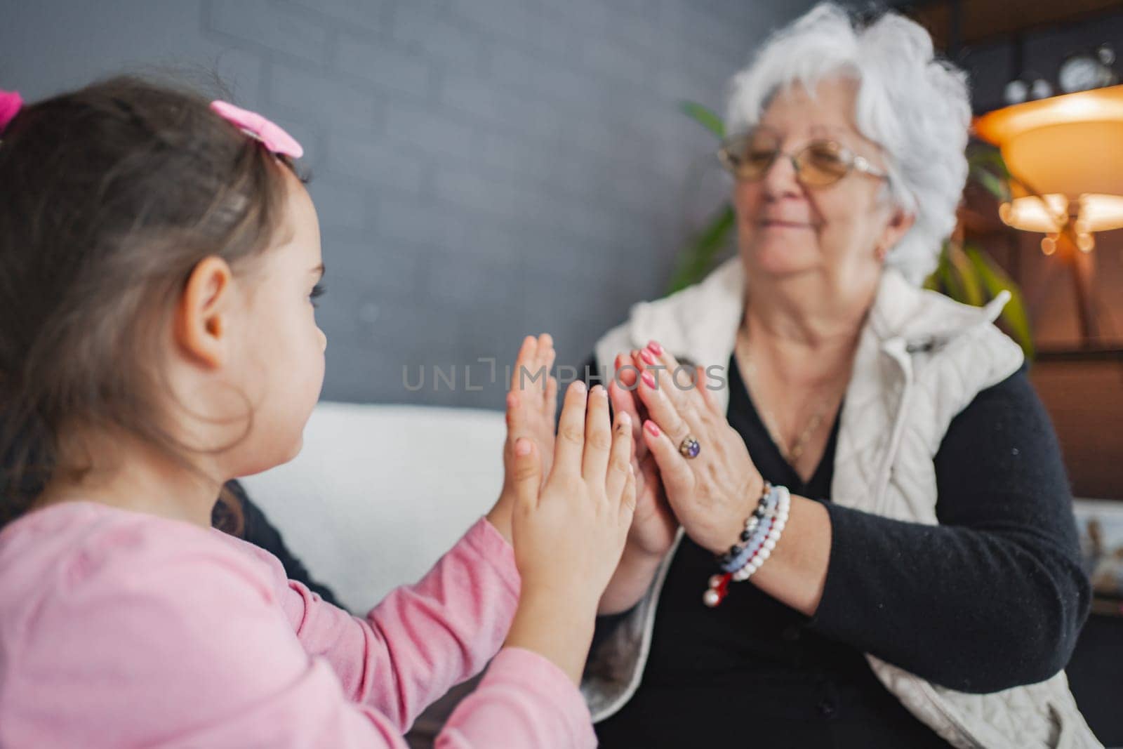 A sweet moment between a girl and her grandmother while playing.