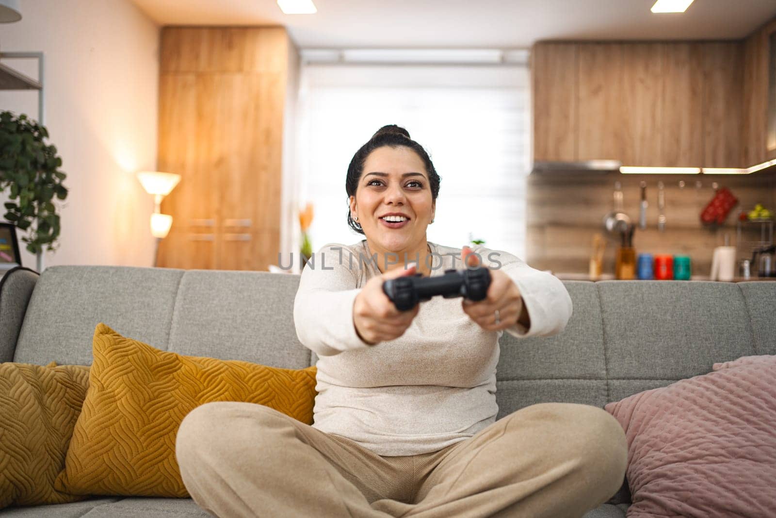 Woman having fun playing video games at home.