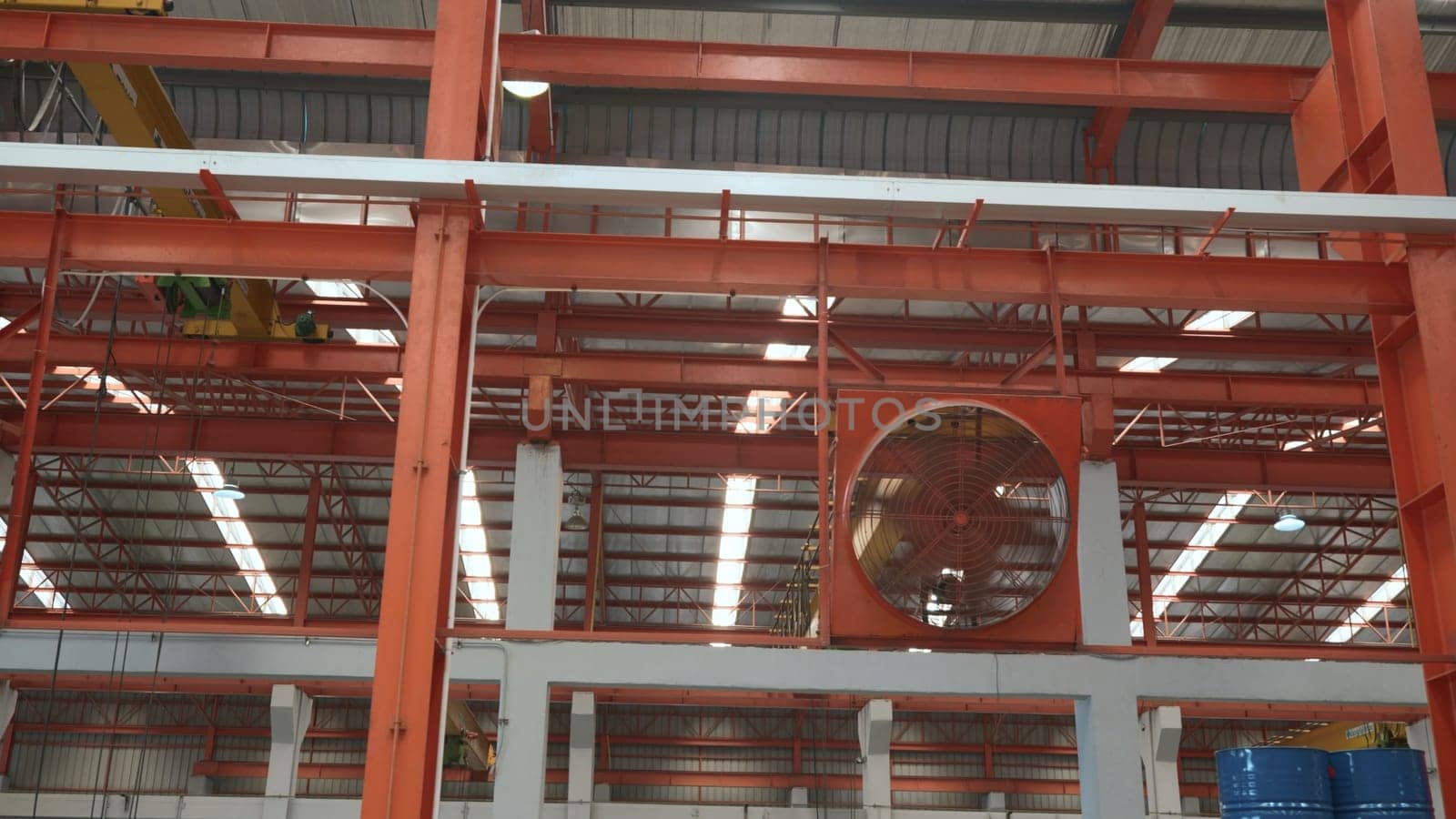 Big industrial cooler red fans in factory for reduced heat in operation ventilation of plant, industry cooling mechanical fan