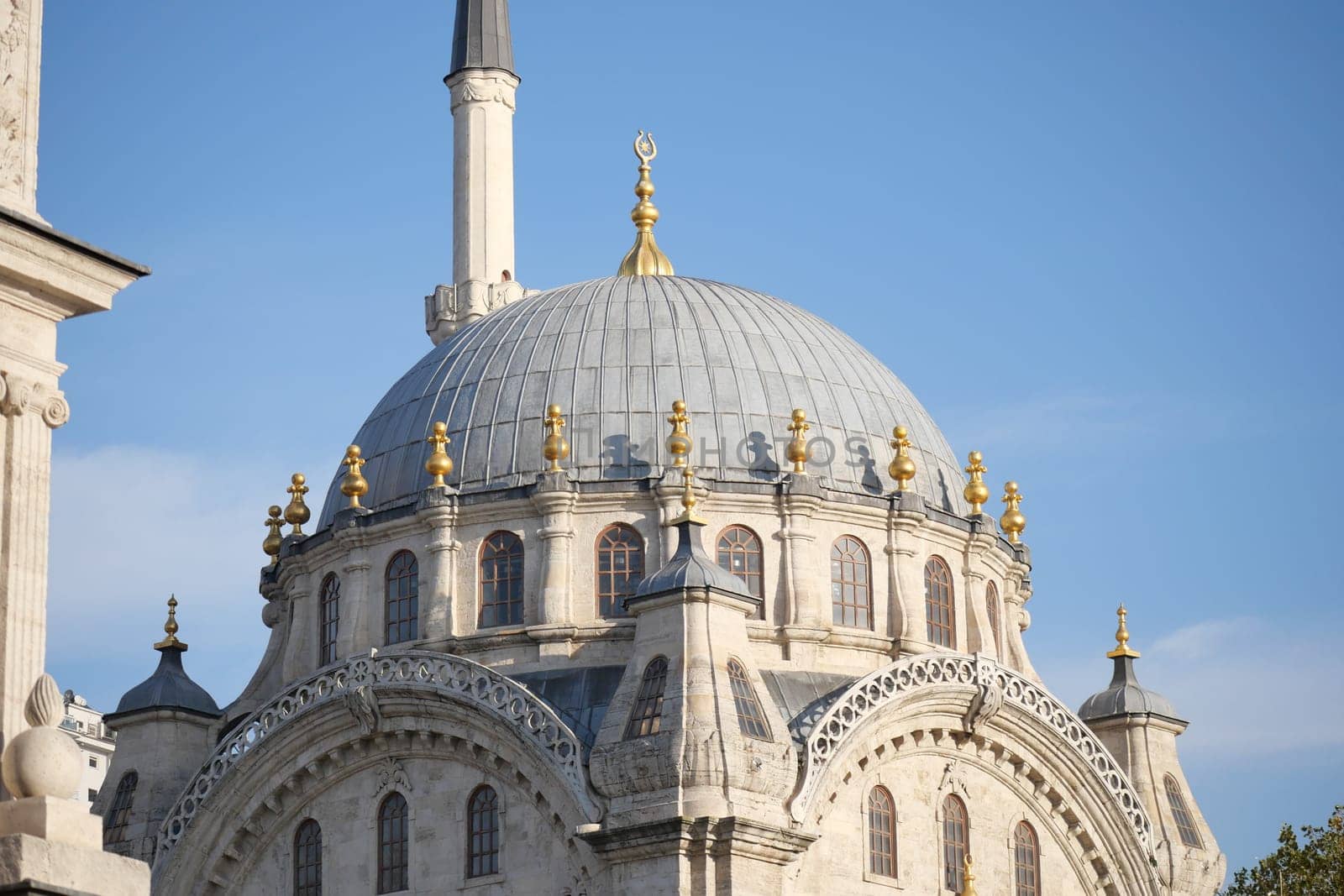 The ornate dome of an ancient mosque sparkles in the sunlight.