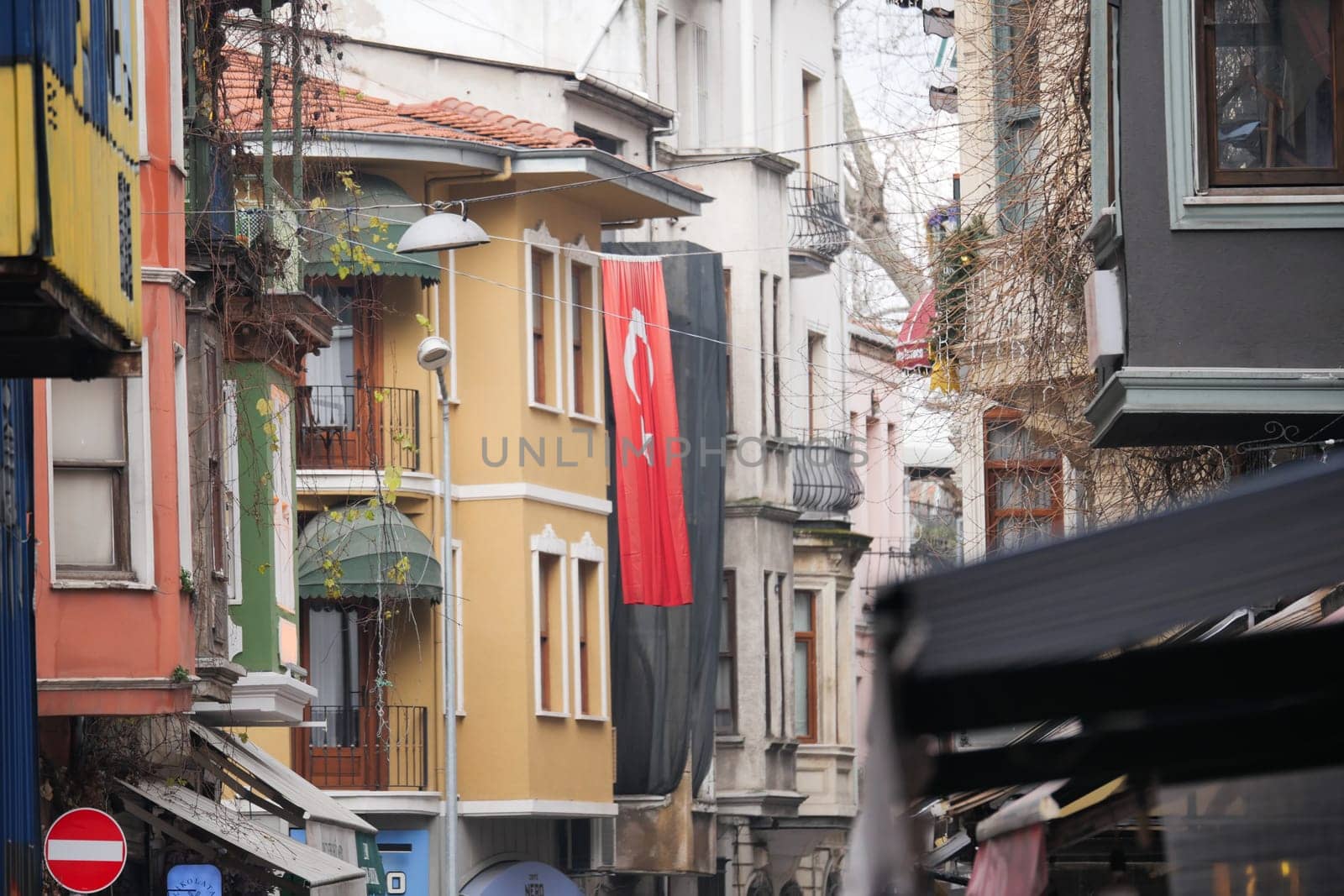 A lively urban street in Istanbul adorned with a Turkish flag.