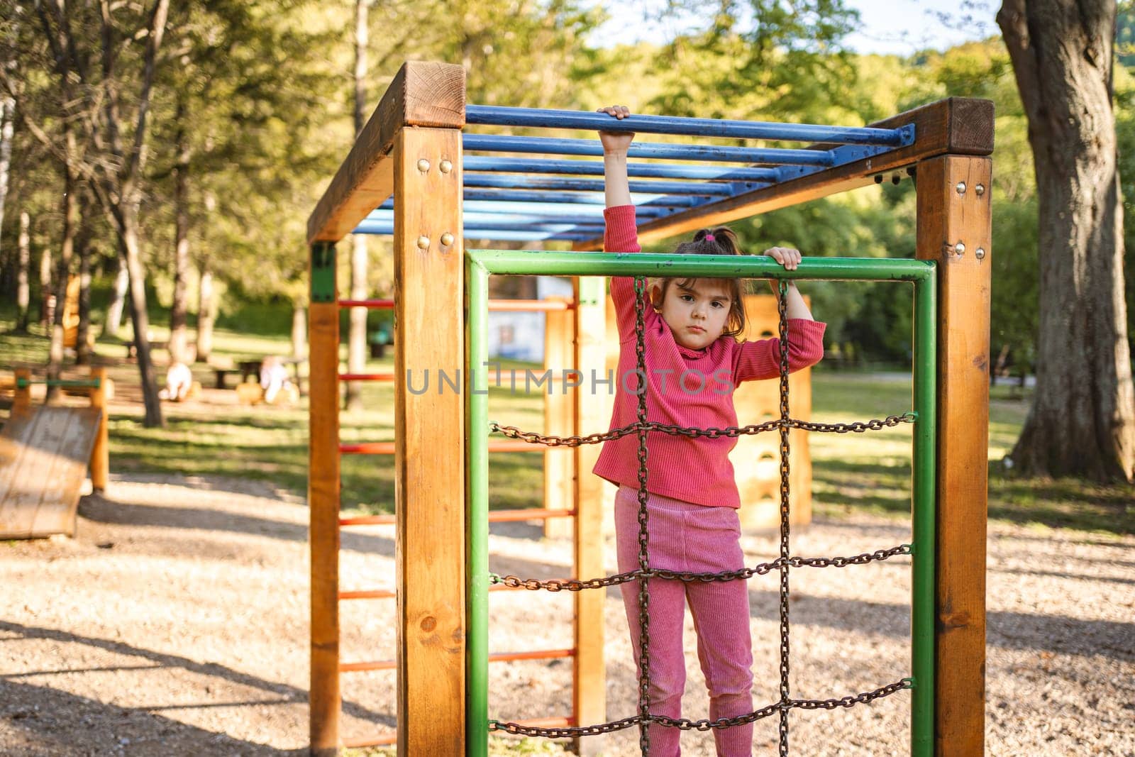 Active cute little girl on the playground.