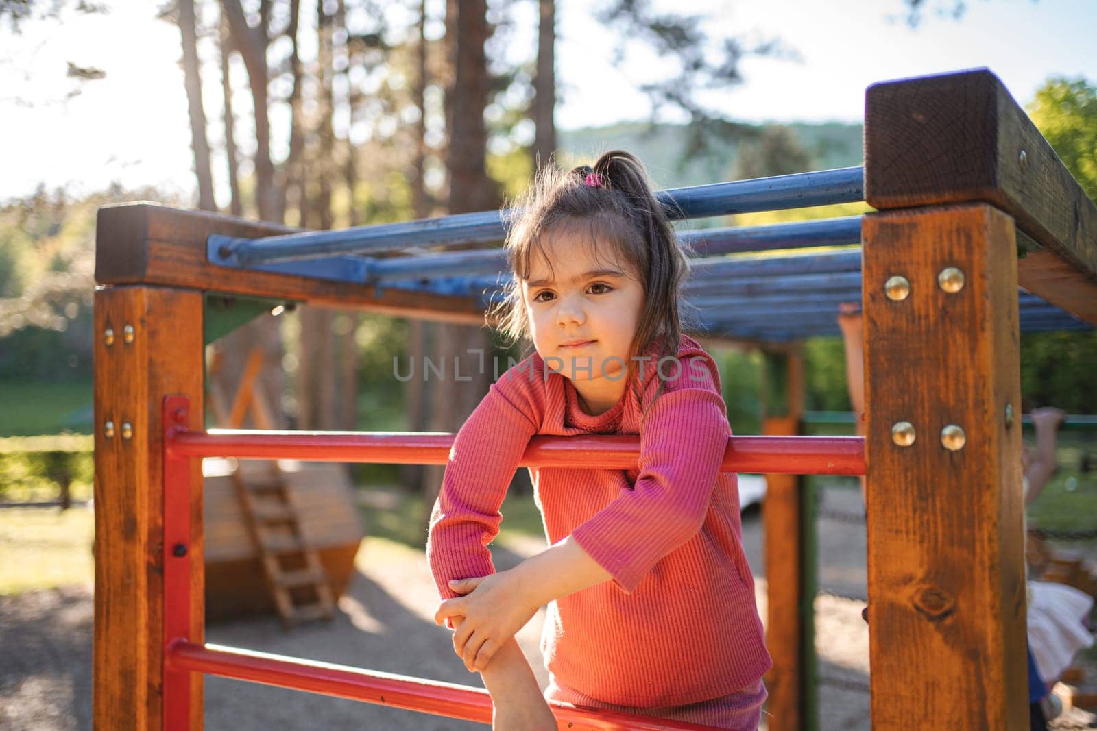 Active cute little girl on the playground.