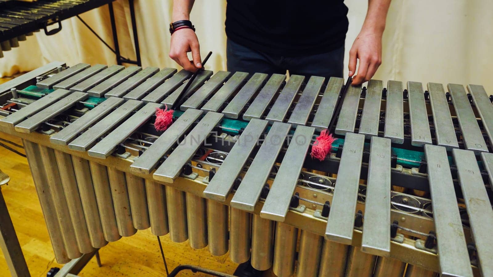 A young guy playing the vibraphone at a music school