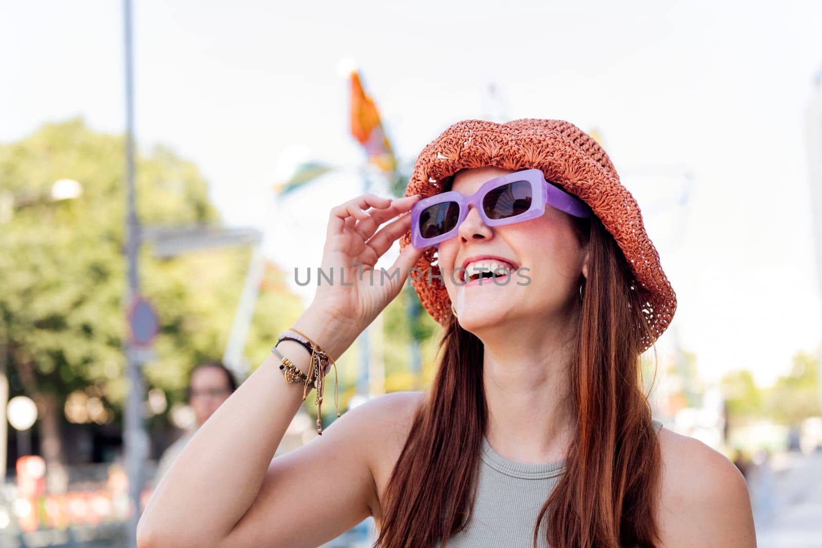 portrait of a young woman with hat and sunglasses laughing happy, concept of youth, copyspace for text