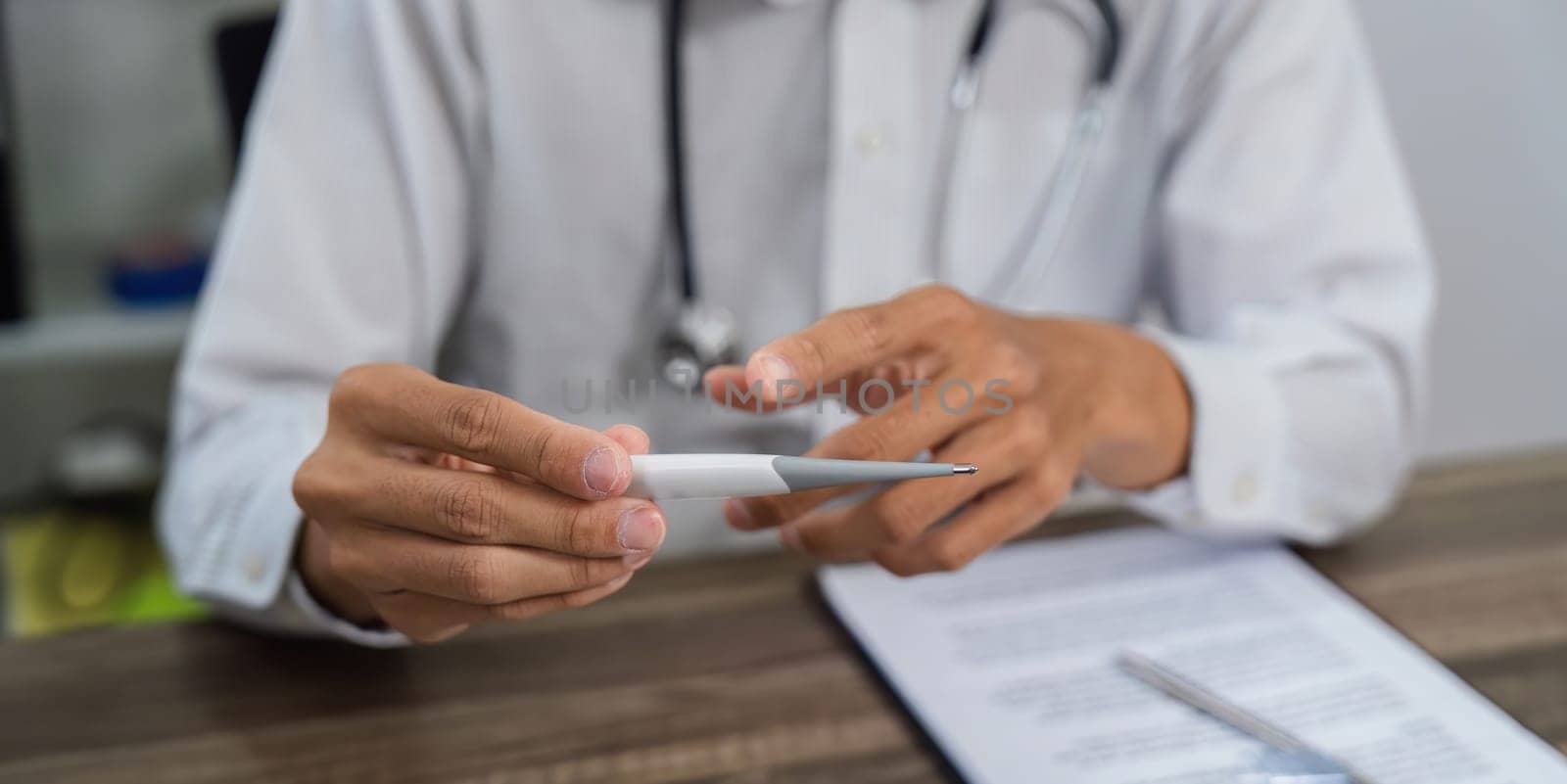An attentive healthcare professional demonstrates the use of medical instruments, helping the patient understand their purpose during the appointment.