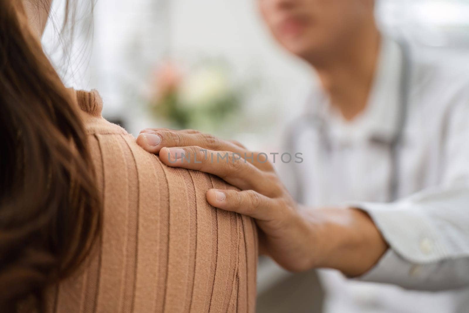 In a warm and supportive environment, a doctor offers comfort to a patient, demonstrating the importance of empathy and human connection in healthcare.