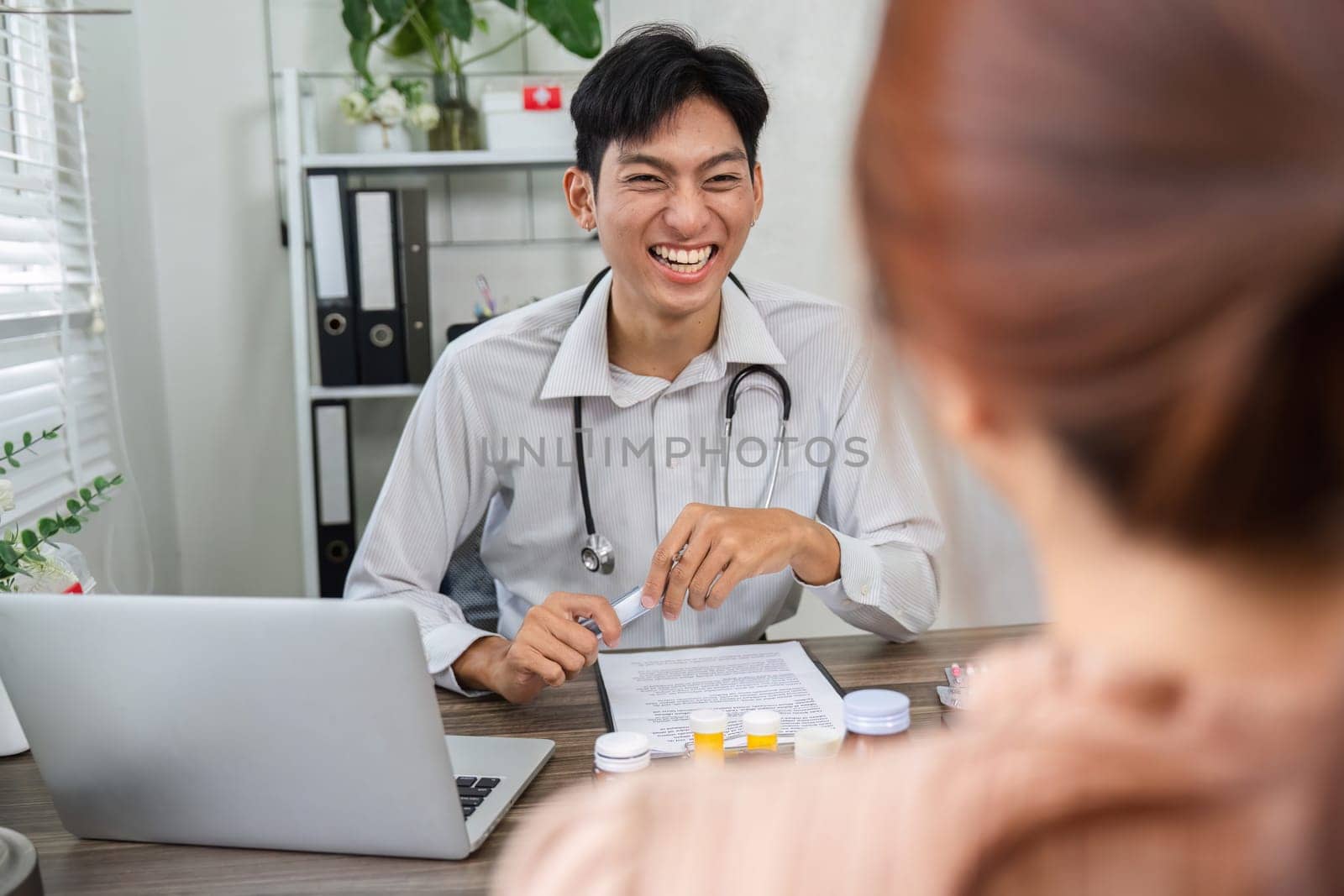 The doctor maintains a cheerful demeanor while explaining treatment options to a patient, ensuring a shared understanding of health goals.
