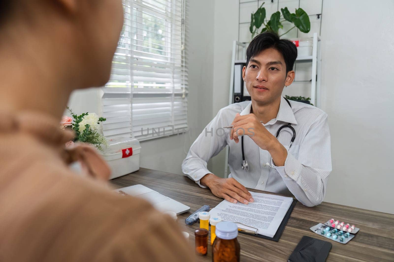 In a professional environment, a doctor reviews medication options with a patient, emphasizing the importance of informed choices in health management and treatment.