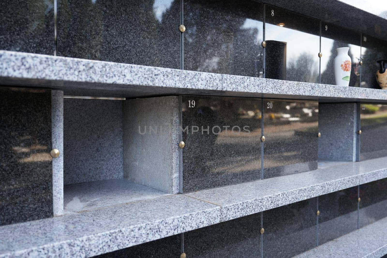 Family columbarium for burial of urns with ashes or coffins European cemetery with graves