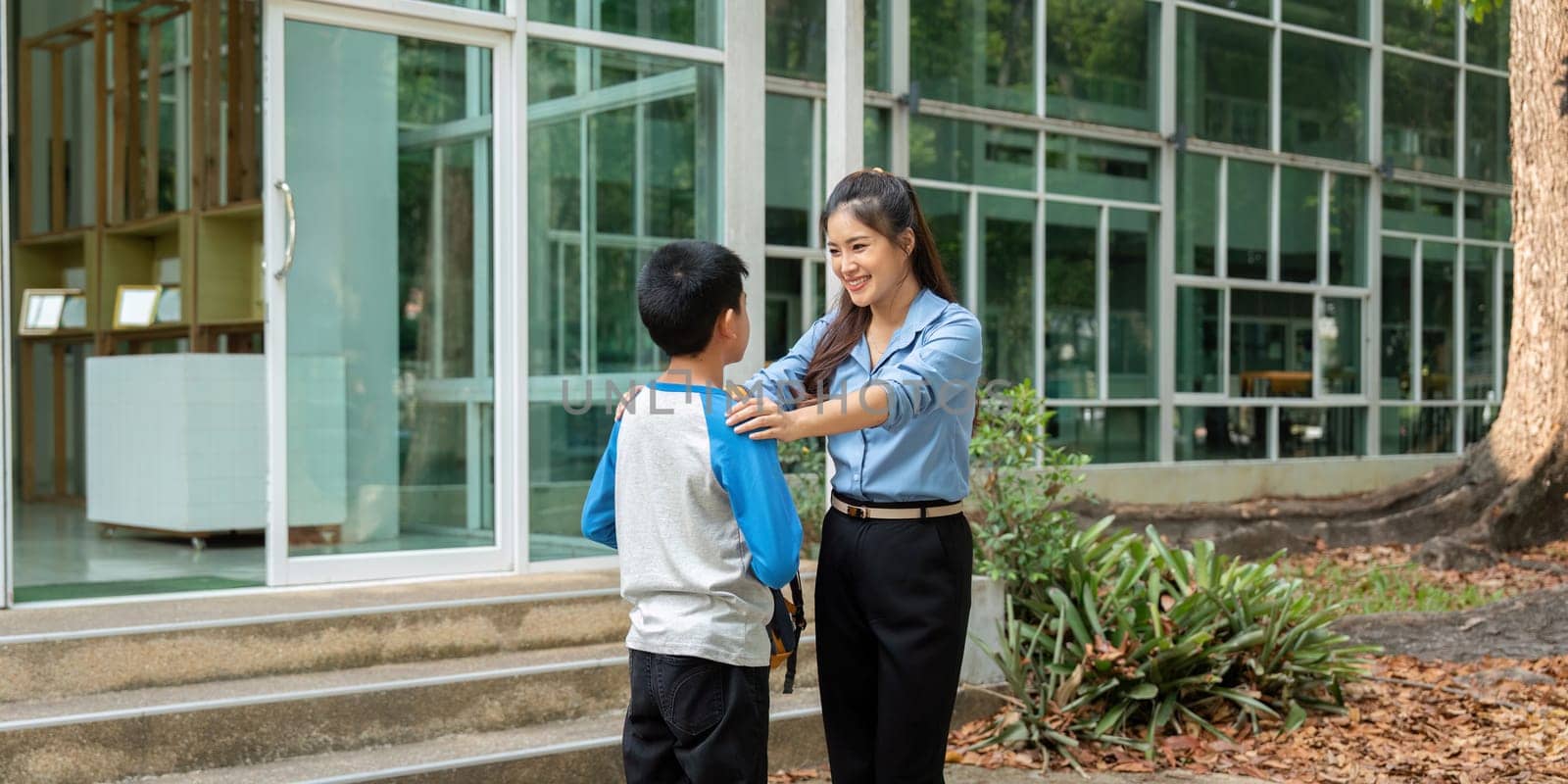 The mother shows affection to her son, who is excited for school. This moment highlights the importance of emotional care in a child's development.