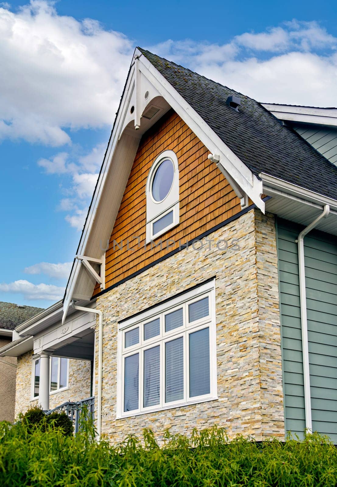 Front side of residential house on cloudy sky background in Canada.