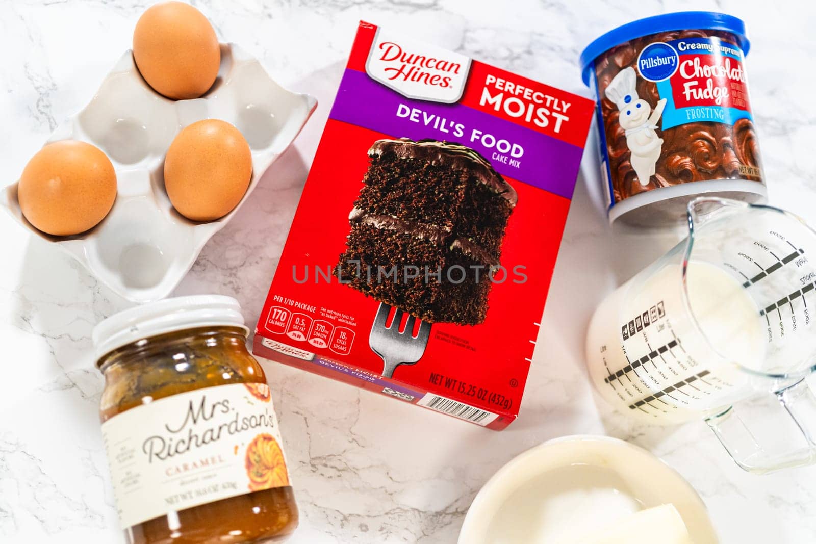 Denver, Colorado, USA-September 7, 2023-Gathered on the kitchen counter are the essential ingredients needed to create irresistible chocolate cupcakes, using a convenient cake mix and luscious chocolate frosting.