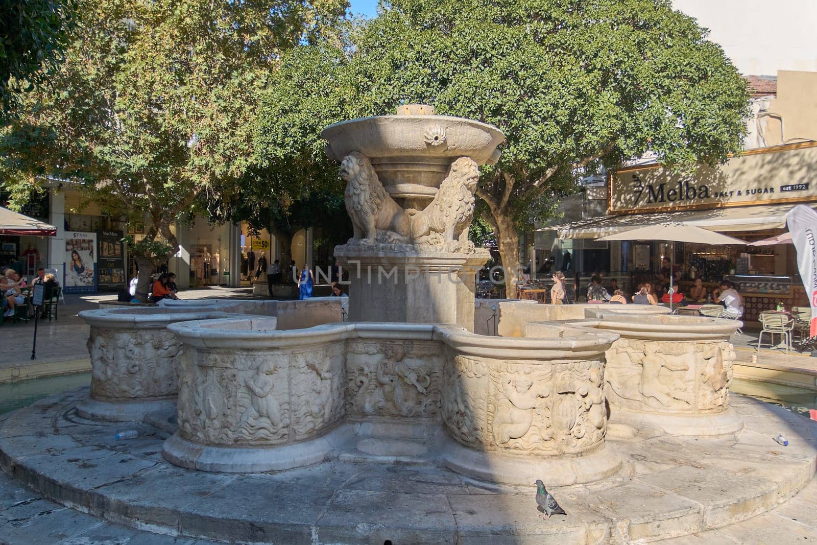 Crete.Greece - april 07, 2025: Ornate Renaissance-era fountain adorned with symbolic lion statues, standing as a serene centerpiece amidst Heraklion’s dynamic urban life and cultural charm.