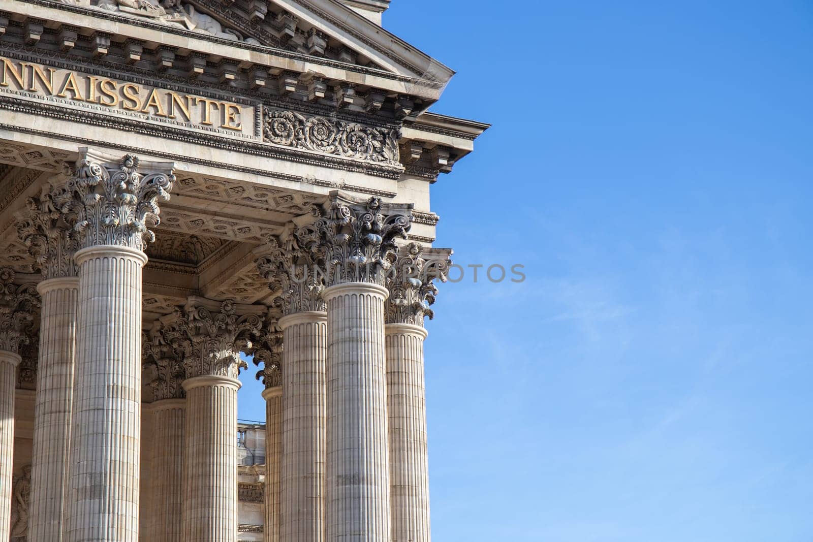 Paris, France - February 22, 2025: A view of the Pantheon under a blue sky, showcasing its classical columns and intricate architectural details