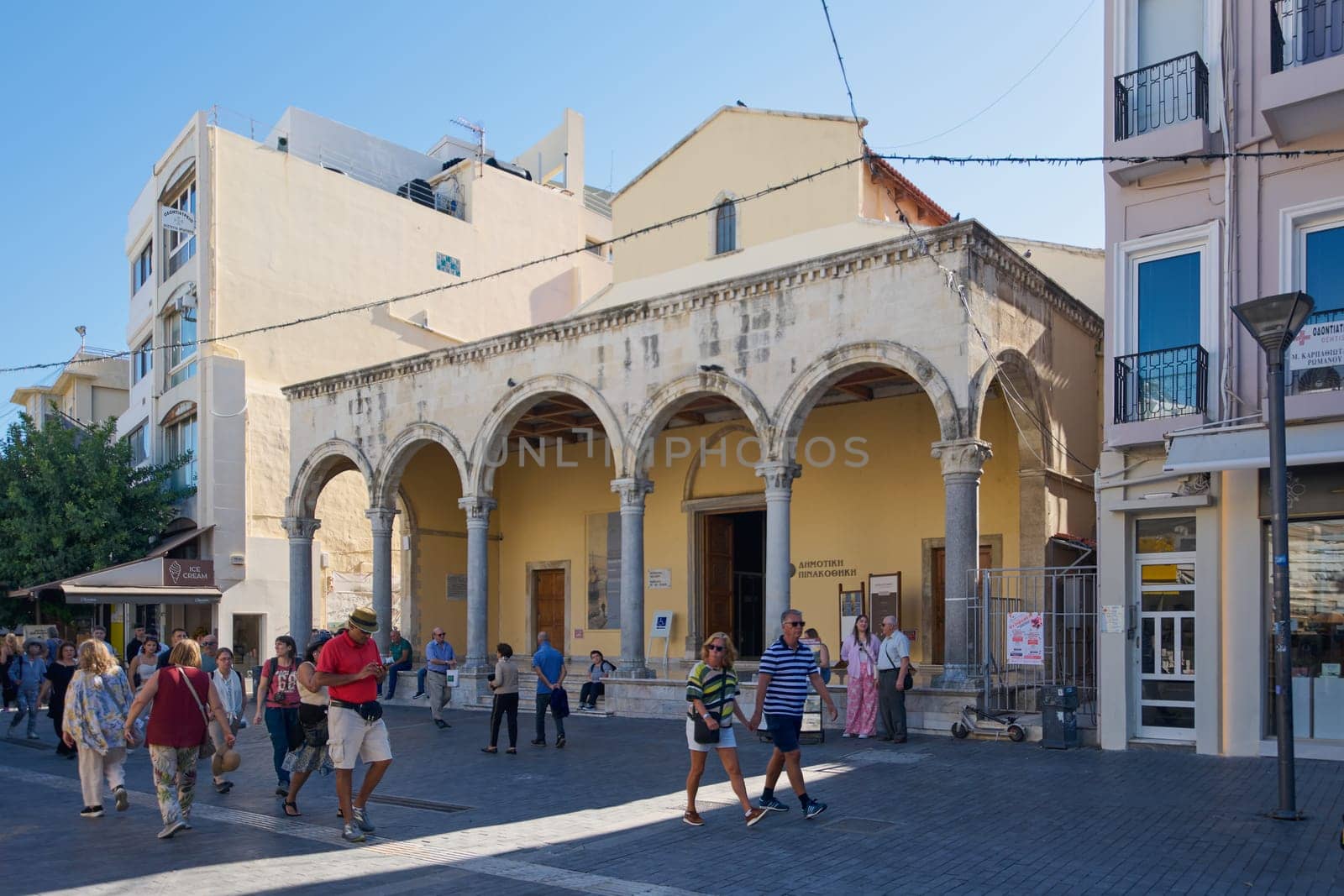 Crete, Greece - April 7, 2025: A charming restaurant in Heraklion featuring outdoor seating, vibrant Mediterranean decor, and a menu showcasing authentic Cretan cuisine in a lively urban setting.