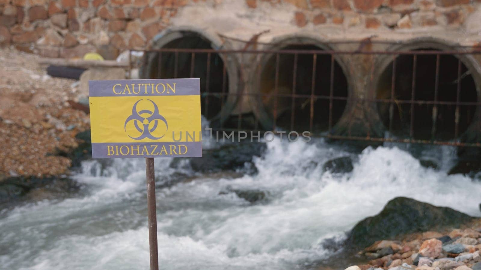 Close up of warning sign lable biohazard caution of collects sample of waste water from industrial, Conserve water and Environment Issue concept