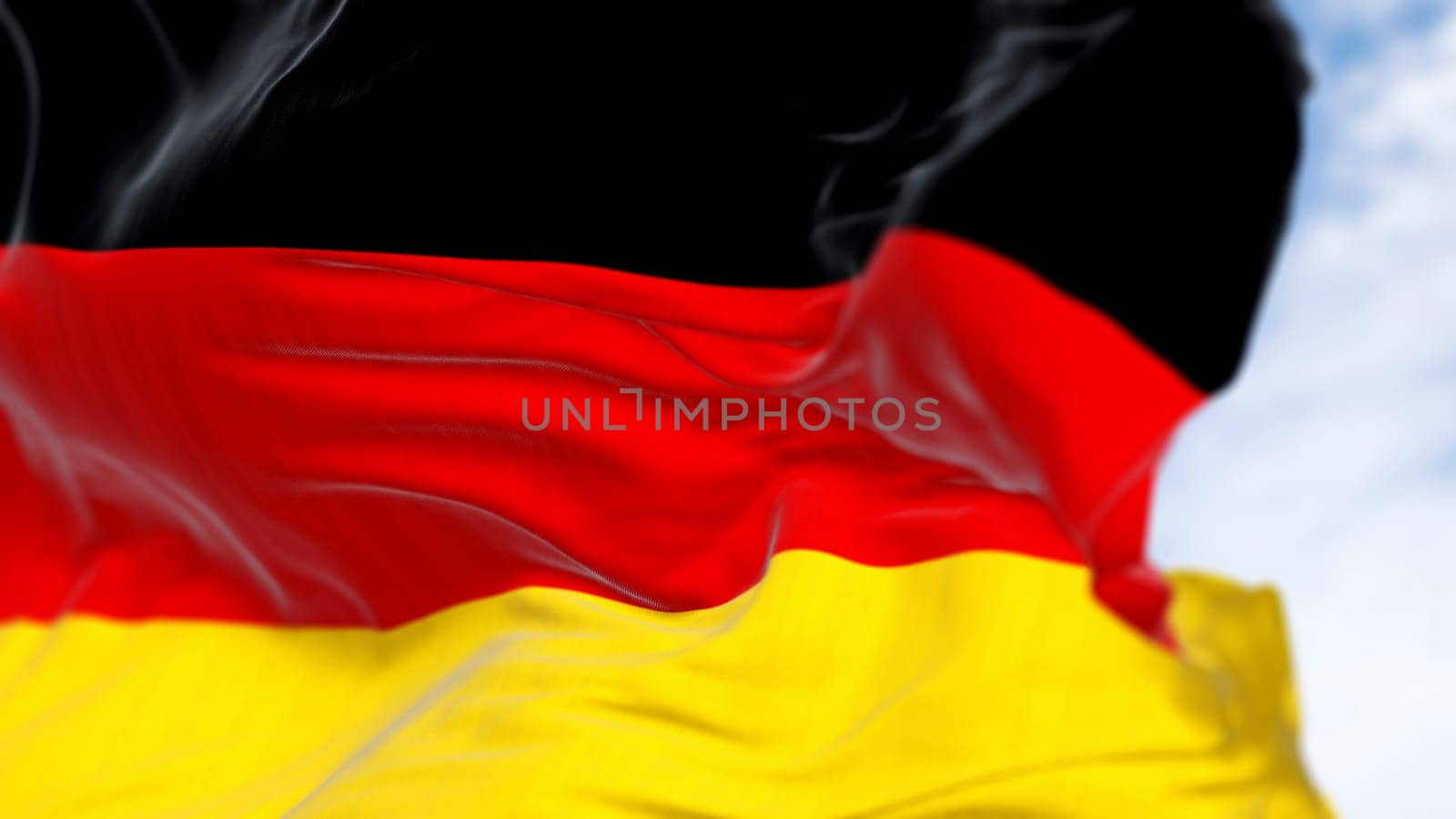 Close-up of Germany national flag waving in the wind on a clear day. Three horizontal bands of black, red and gold. 3d illustration render. Rippled fabric. Selective focus