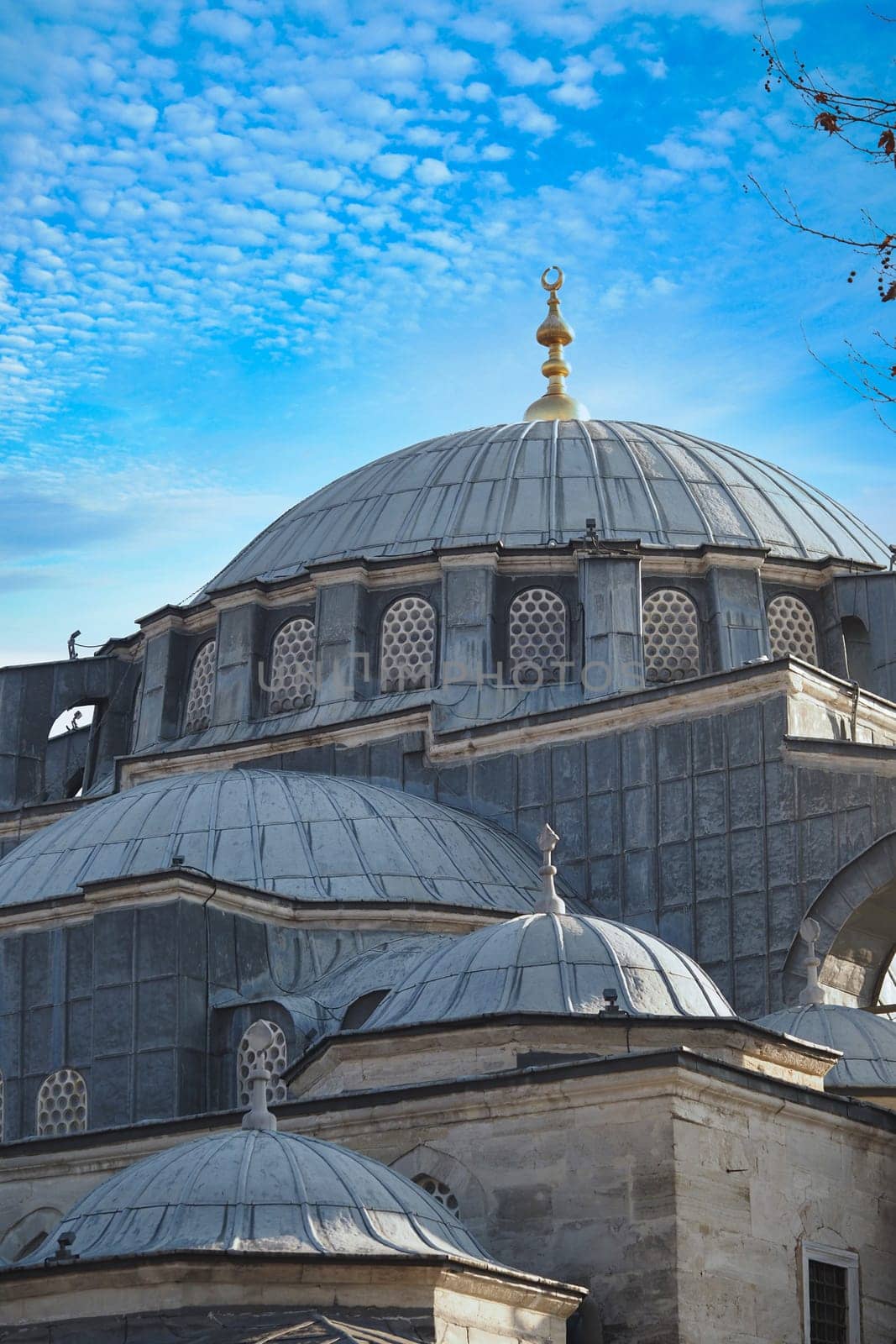 Beautiful domes of a historic mosque stand out against a vibrant sky.