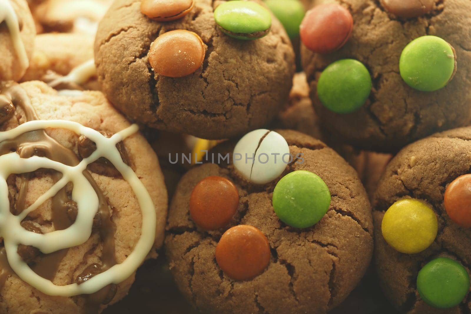 Colorful cookies featuring chocolate chips and sweet toppings beckon delight.