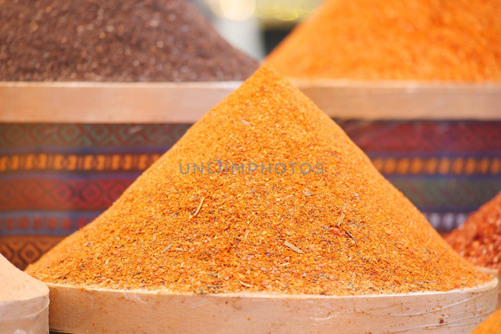 Vibrant spices fill market stalls, highlighting their colorful variety.