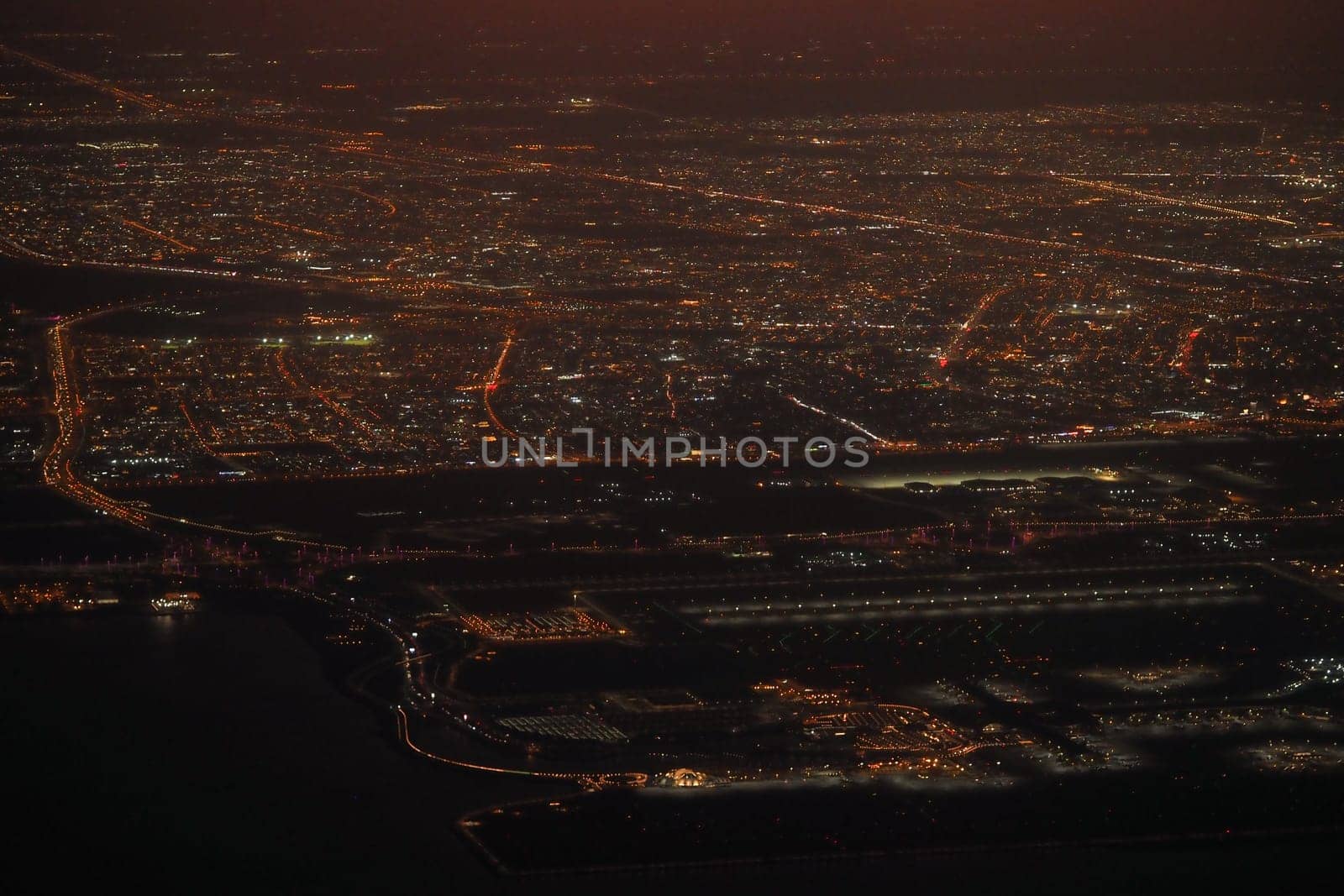 Aerial view of a vibrant urban landscape sparkling at night.