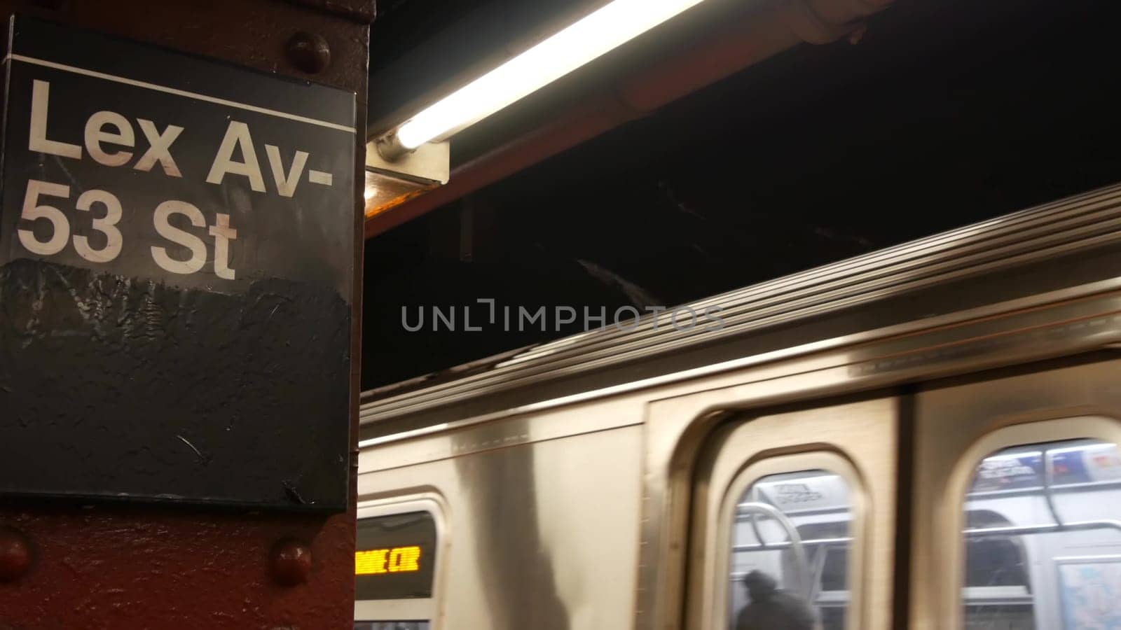 New York City, United States - 30 Aug 2023: Subway station, underground metropolitan platform sign. Metro train, railway public transport. Text signboard: Lexington Avenue. Lex Av. Midtown Manhattan.