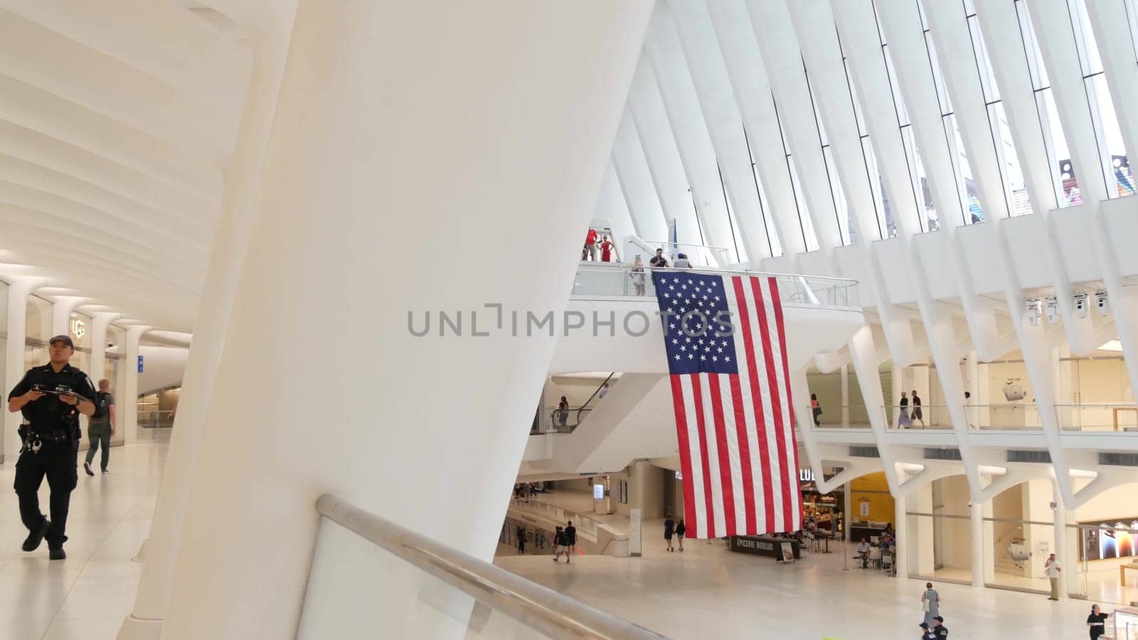 New York City, United States - 10 Sept 2023: World Trade Center Oculus building. Manhattan Downtown Financial District, USA urban life. People. September 11 remembrance american flag. Police officer.