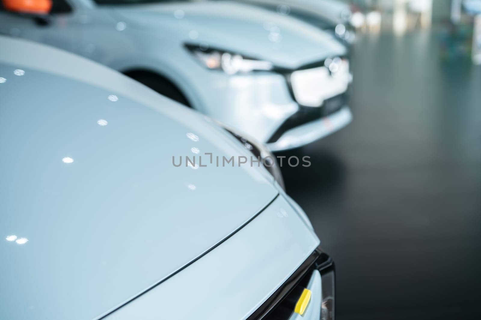 Car parked in luxury showroom. Car dealership office. Car showroom business. New car parked in modern showroom. Auto for sale and rent business. Automobile leasing and insurance. Electric automobile.