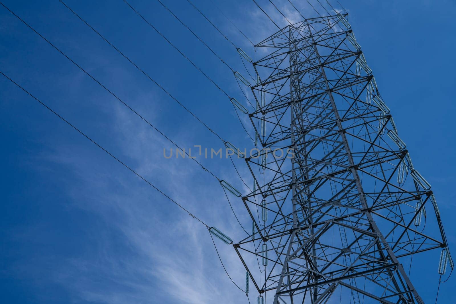 High voltage tower providing electric power transmission, emphasizing industrial infrastructure, supply networks, energy technology, and the critical role of power in addressing the energy crisis.