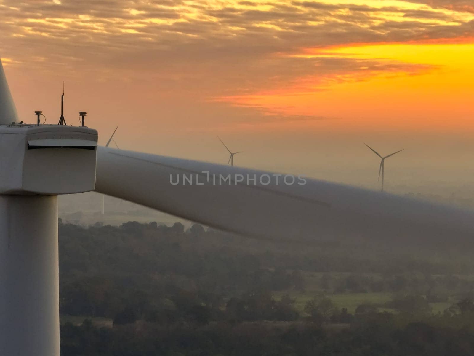 Wind farm field and sunset sky. Wind power. Sustainable, renewable energy. Wind turbines generate electricity. Sustainable development. Green technology for energy sustainability. Eco-friendly energy.