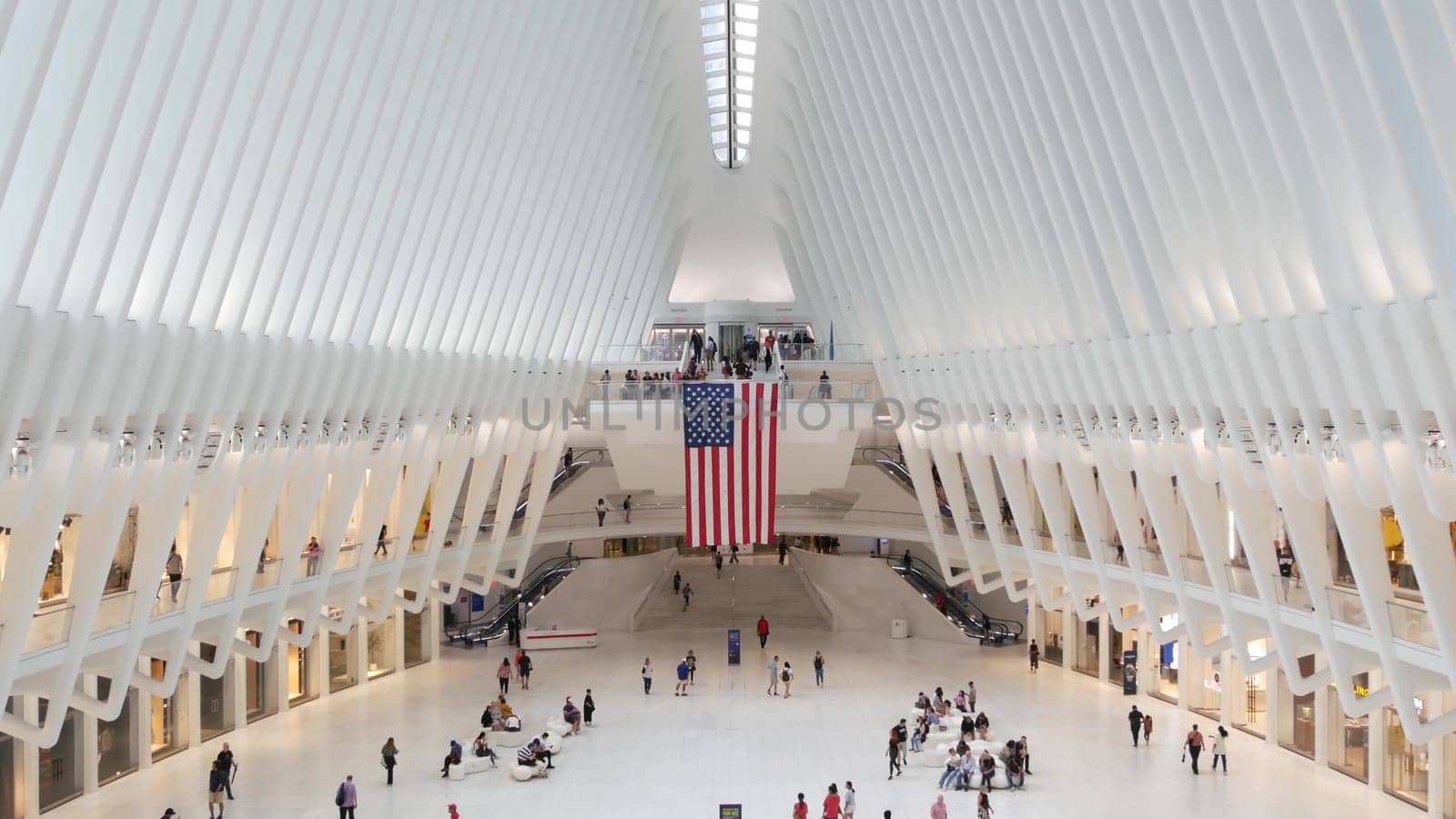 New York City, United States - 10 Sept 2023: World Trade Center Oculus transport hub architecture. Manhattan Downtown Financial District, USA urban life. People. September 11 remembrance american flag