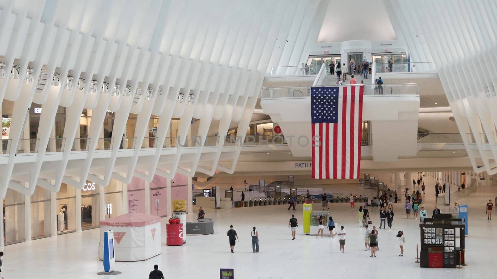 New York City, United States - 10 Sept 2023: World Trade Center Oculus transport hub architecture. Manhattan Downtown Financial District, USA urban life. People. September 11 remembrance american flag