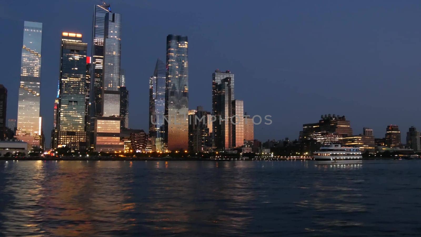 New York City, United States - 4 Sept 2023: Manhattan Midtown skyline from river ferry boat. Hudson Yards skyscrapers from ferryboat. Waterfront panorama riverfront architecture. Empire State Building
