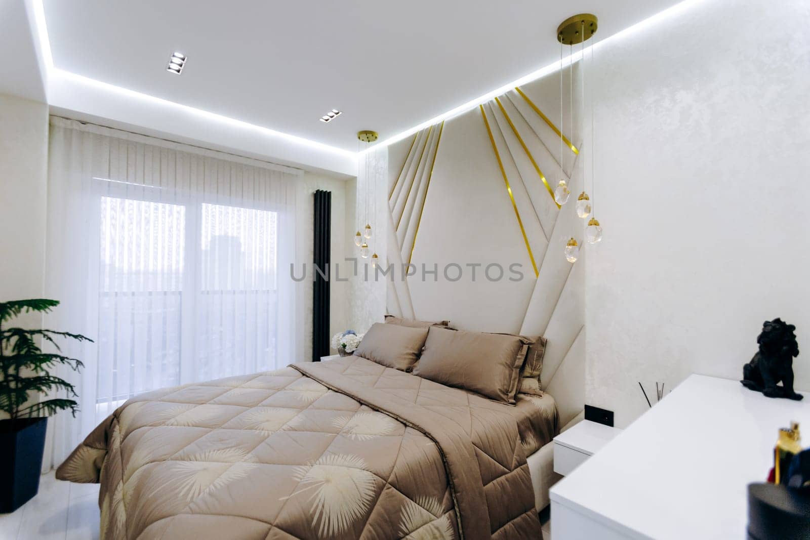 A cozy bedroom featuring a comfortable bed, a sleek nightstand, and a large window allowing natural light to stream in