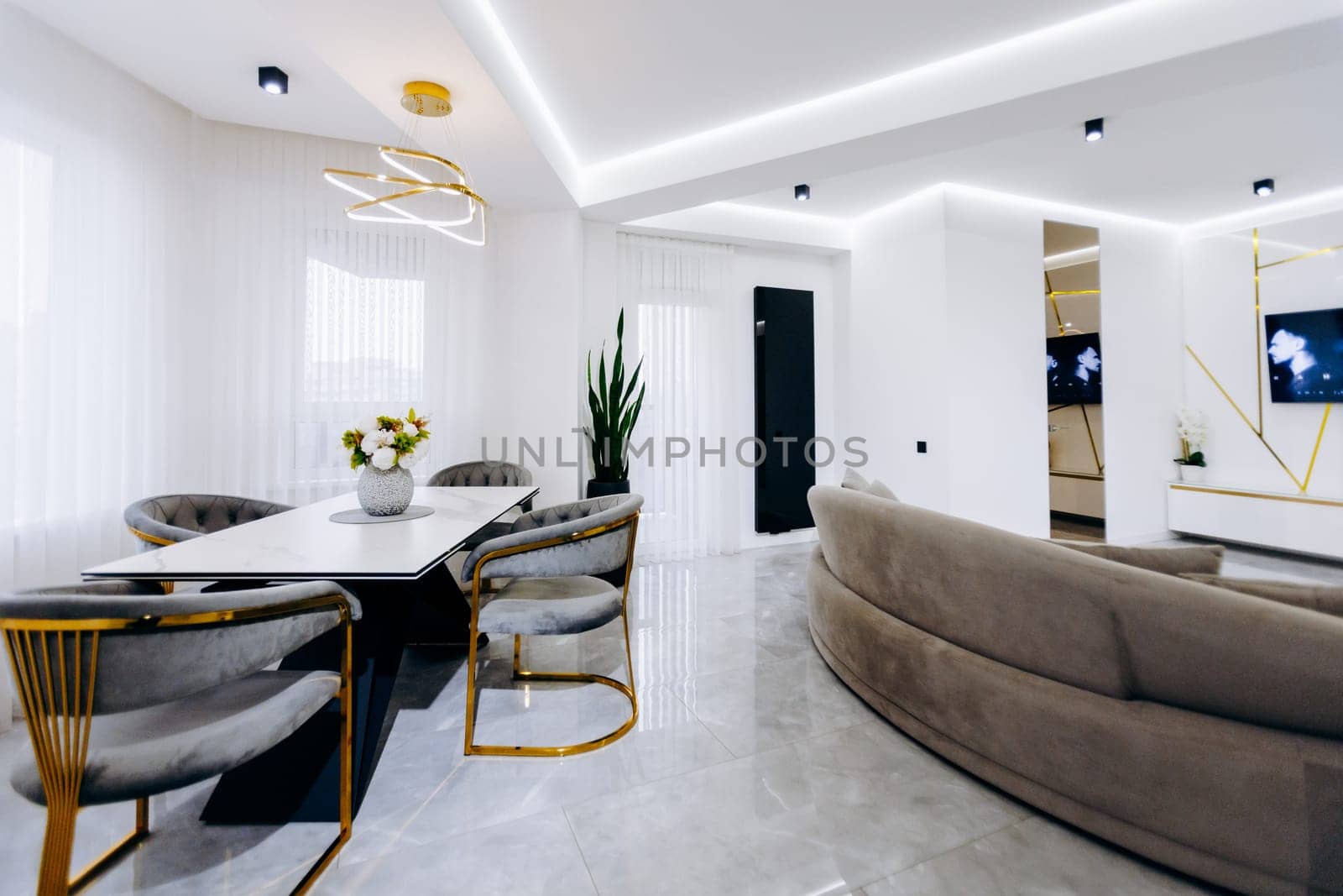 A cozy and inviting living room that features a dining table paired with chairs alongside a comfortable couch for relaxation