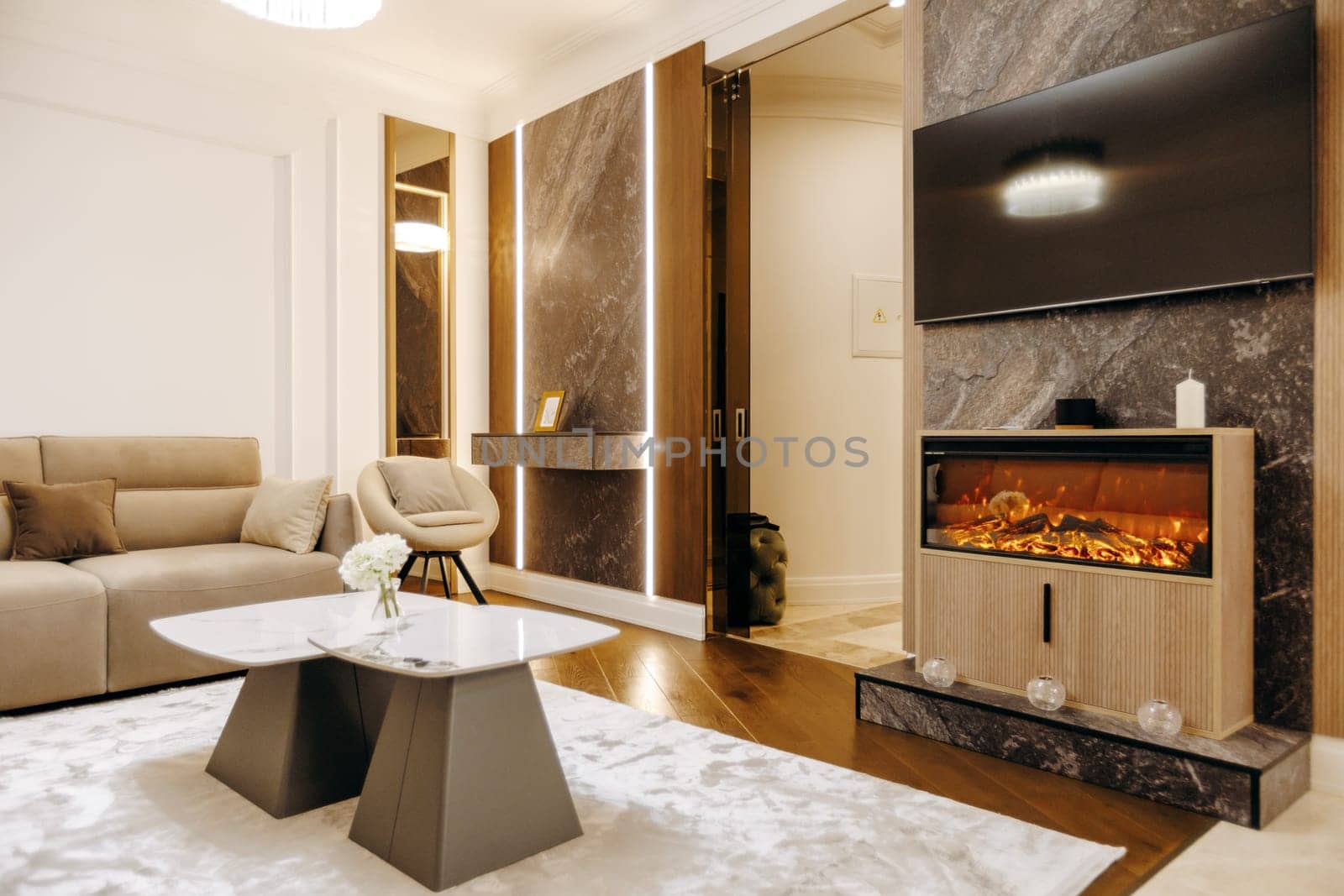 Imagine a cozy living room that features a warm fireplace along with a sleek, modern flat screen television mounted on the wall