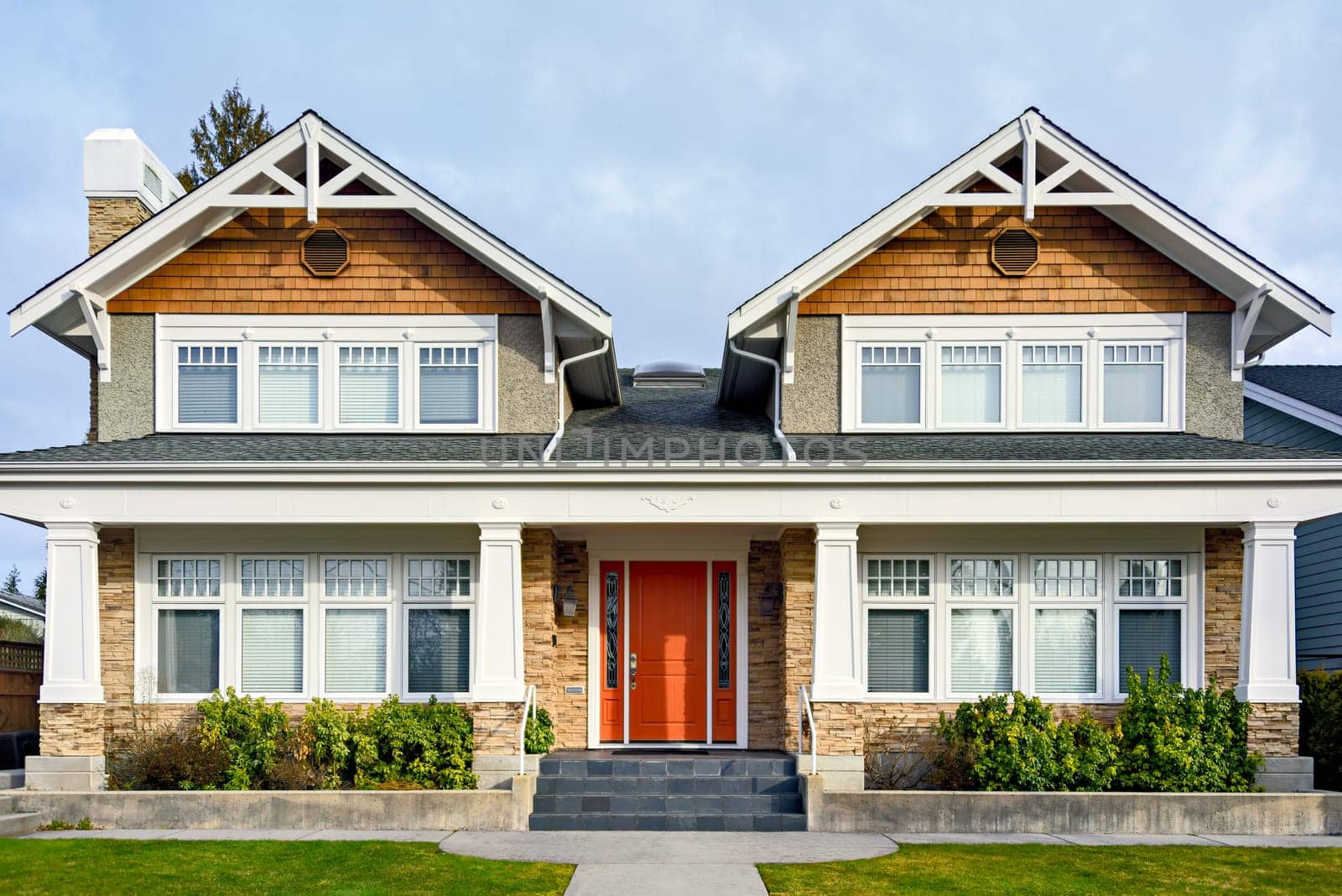 A perfect neighbourhood. Luxury family house with nicely landscaped front yard and concrete pathway to the entrance