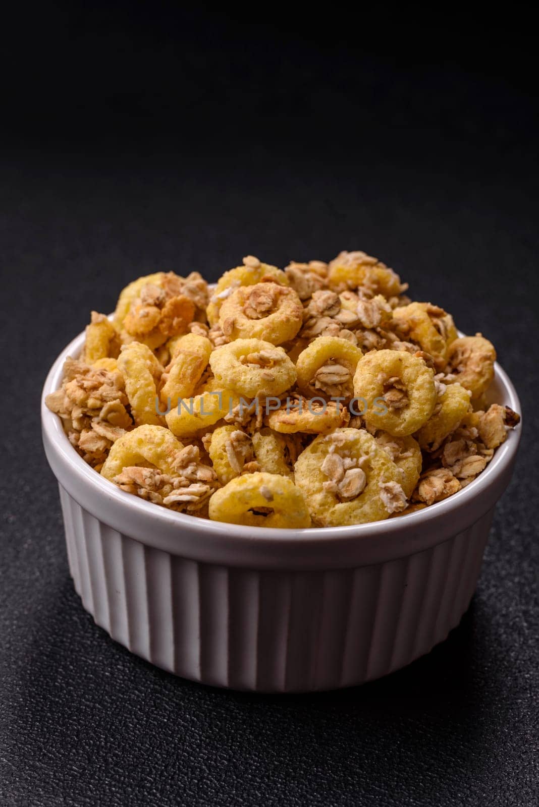 Flakes, chocolate balls and dried fruit for a hearty breakfast. Granola with chocolate flakes