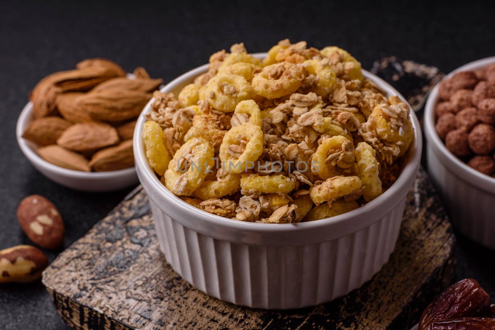 Flakes, chocolate balls and dried fruit for a hearty breakfast. Granola with chocolate flakes